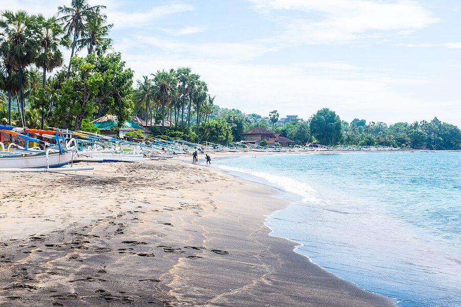 Fishing jukungs hauled up on the black sand beach in Amed village