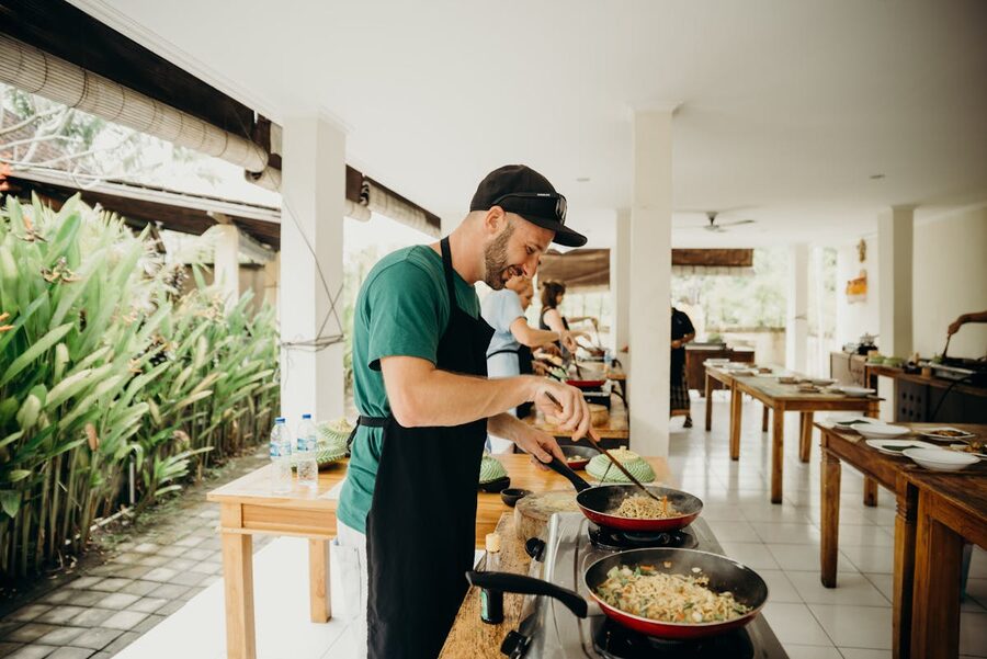 Chef preparing food in an open-air kitchen in Bali