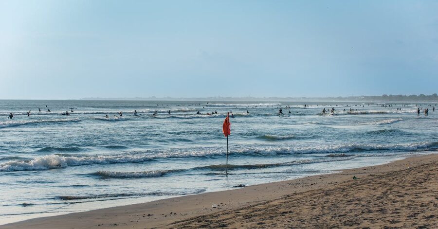 Canggu beach with surfers riding small waves