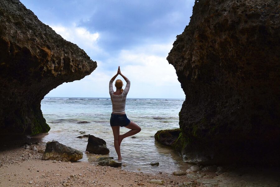 Yoga on a Bali beach with the ocean in view