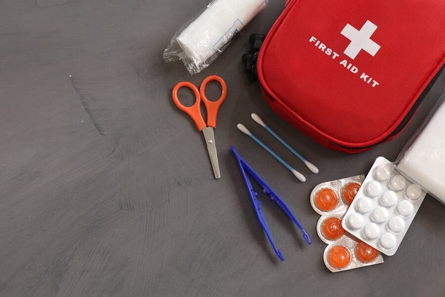 Open first aid kit with travel medical supplies and oral rehydration sachets