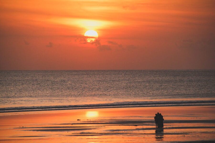 Couple silhouette on Kuta Beach Bali at sunset