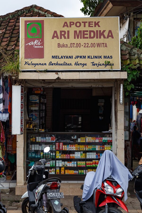 Apotek Ari Medika pharmacy storefront in Ubud Bali with mopeds parked outside