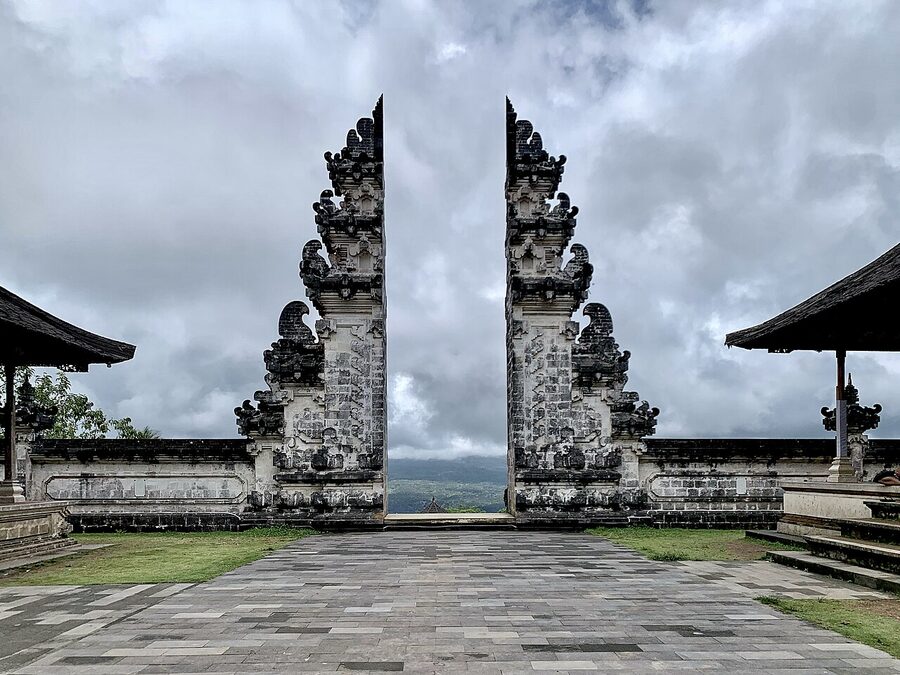 The split candi bentar gateway at Pura Lempuyang in east Bali, framing the cloudy mountain landscape between the two stone halves
