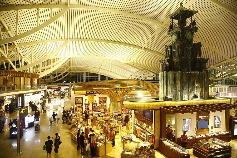 The interior of Ngurah Rai International Airport terminal showing the airside commercial area