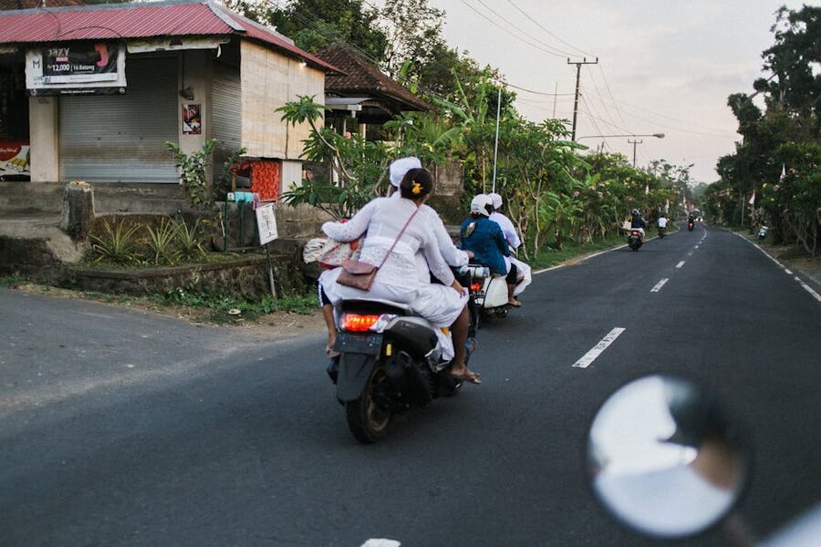 People riding mopeds on Bali road heading inland