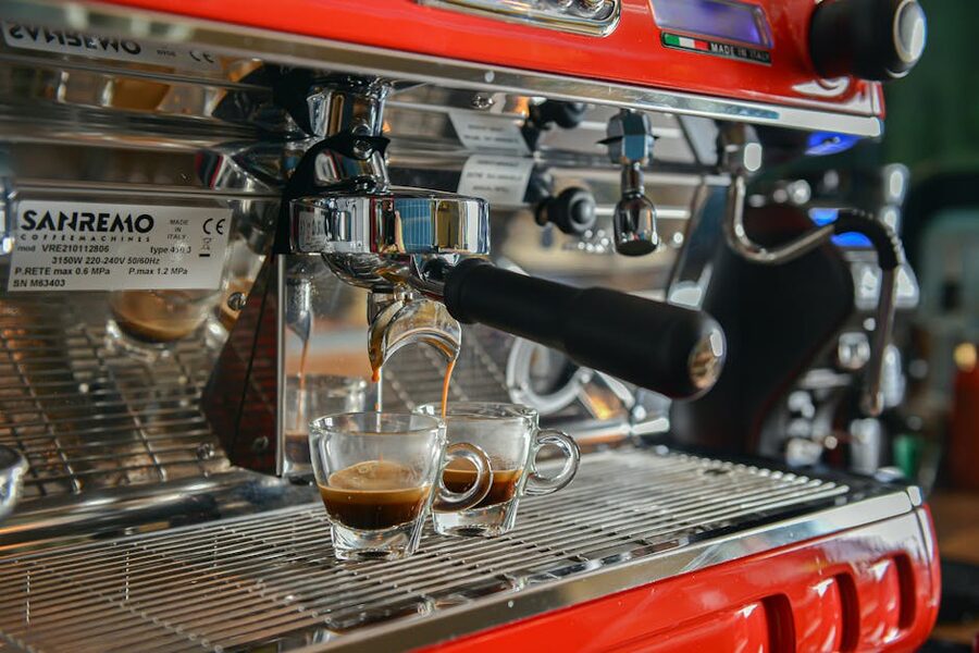 Espresso pouring from a Sanremo machine into cups