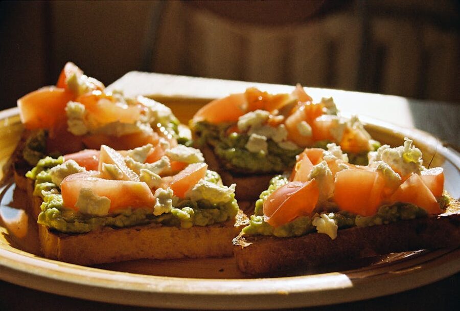 Avocado toast with fresh tomato and seed toppings