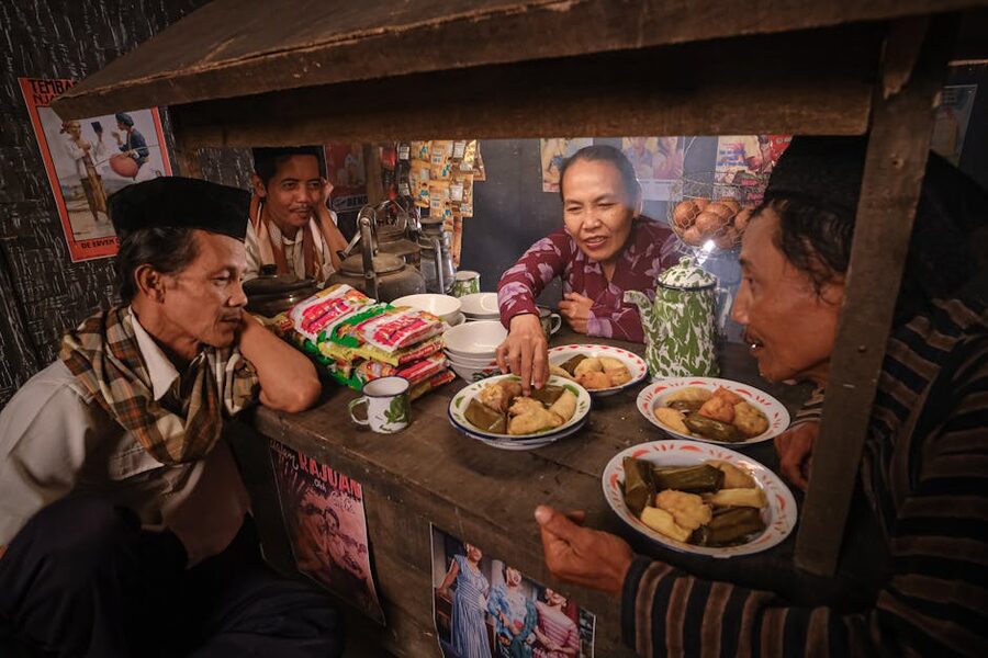 Friends at a traditional Indonesian warung enjoying snacks