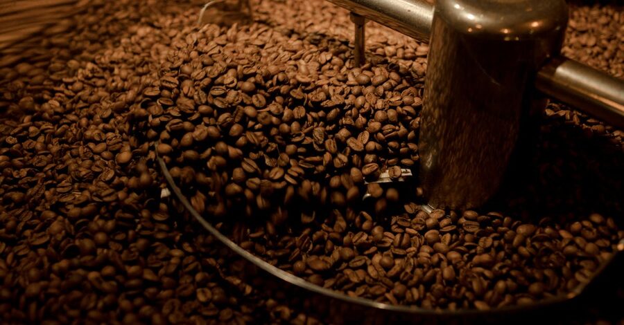 Coffee beans being roasted in a commercial coffee roaster at an Ubud roastery