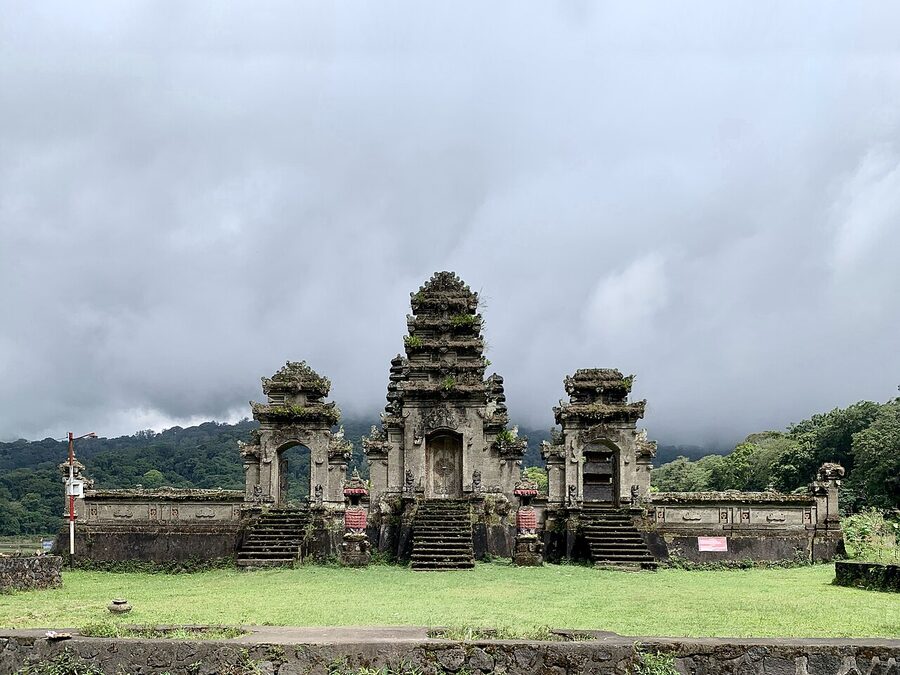 Pura Ulun Danu Tamblingan with moss-covered stone gates under low cloud