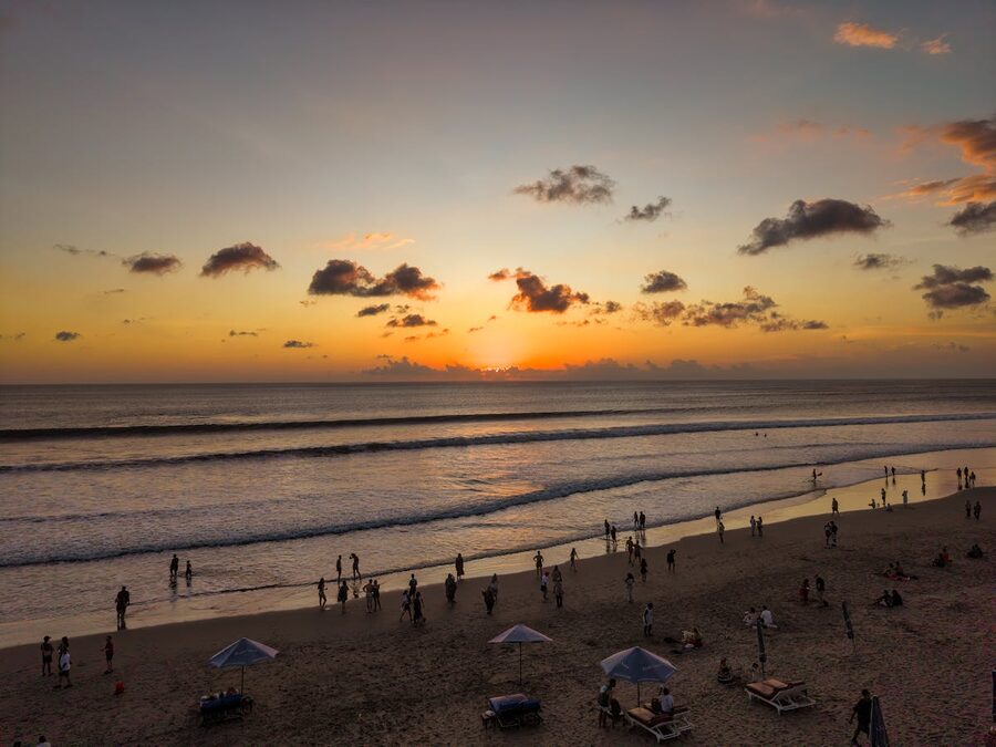 Sunset on Kuta Beach Bali with people on the sand