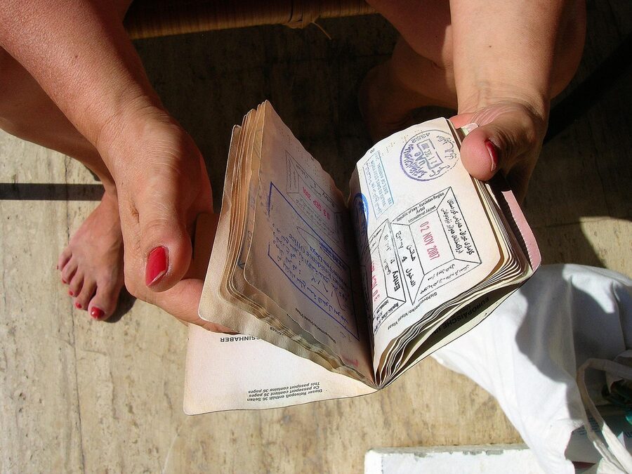 A passport with multiple visa stamps held open