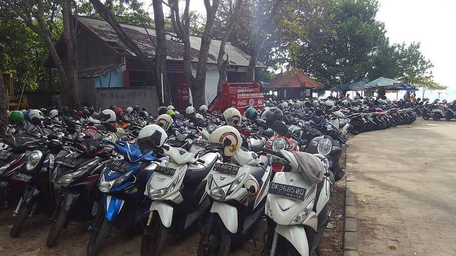 Mopeds parked in rows at Kuta Beach in Bali