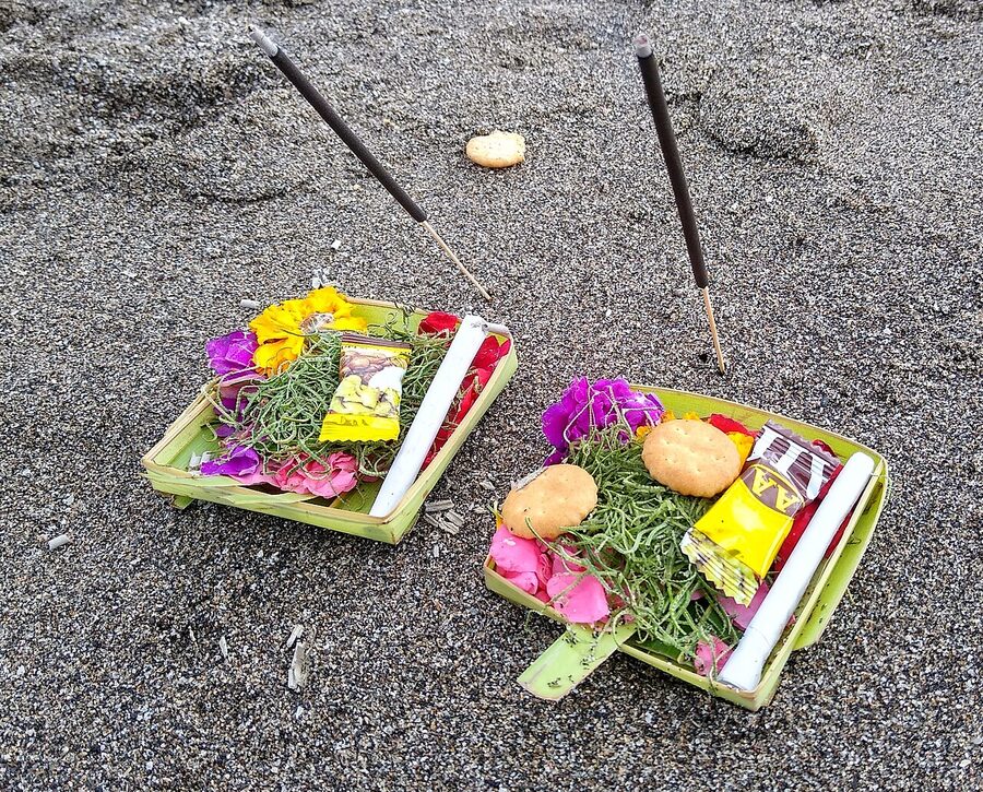 Daily Balinese canang sari offering on a temple shrine