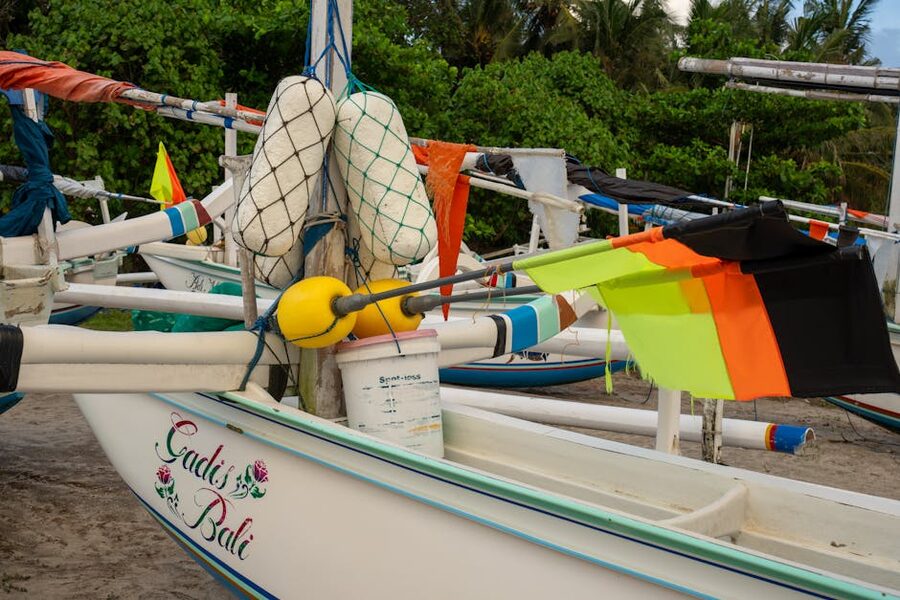 Colourful Sanur jukung boats with offering flags