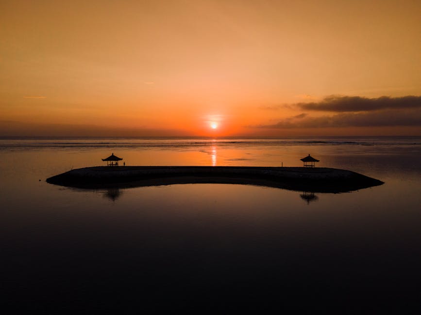 Island in calm water at sunrise
