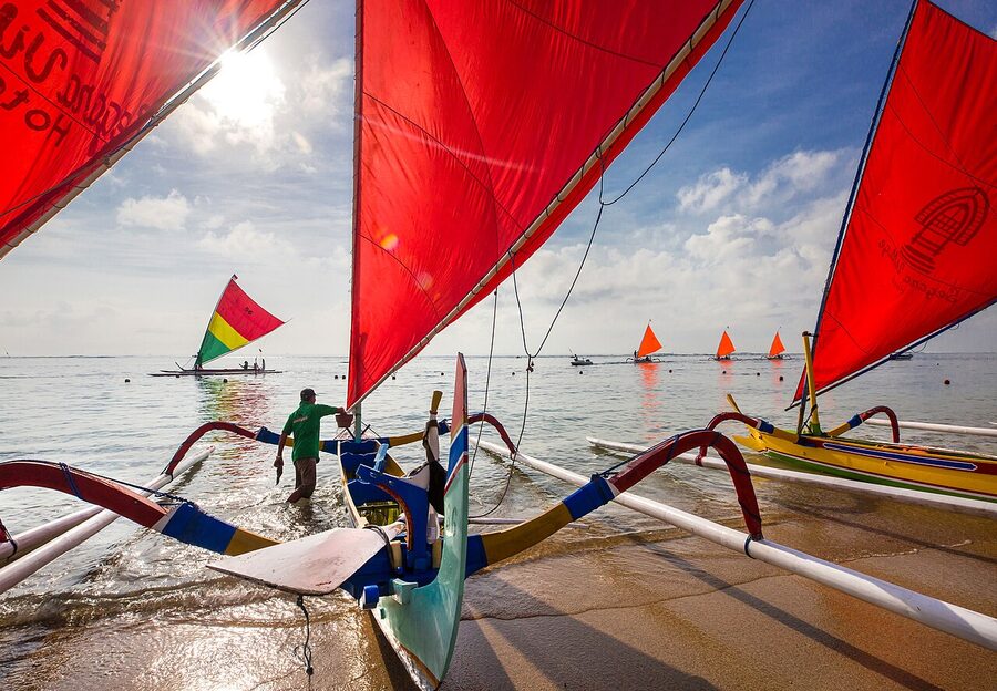 Traditional jukung outrigger boat parked on Sanur beach