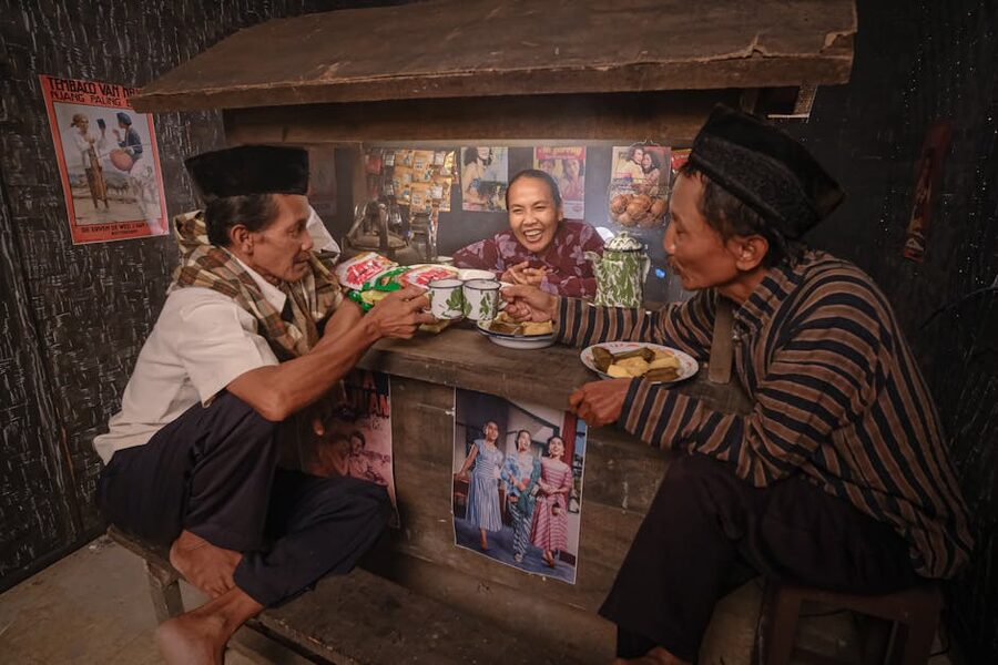Locals chatting and drinking at a small Indonesian warung kopi