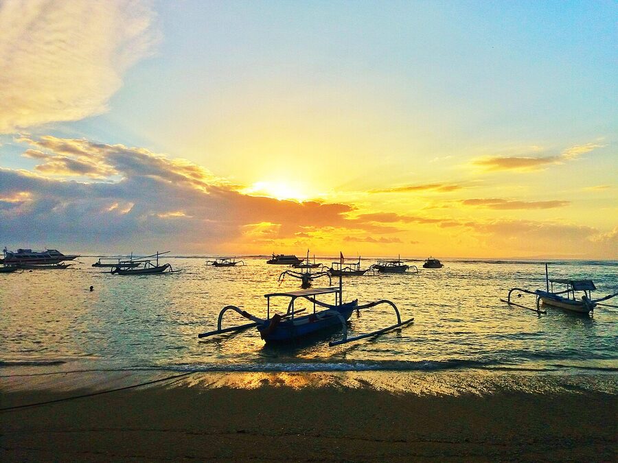 Morning view of Sanur Beach Bali with fishing boats on the shoreline