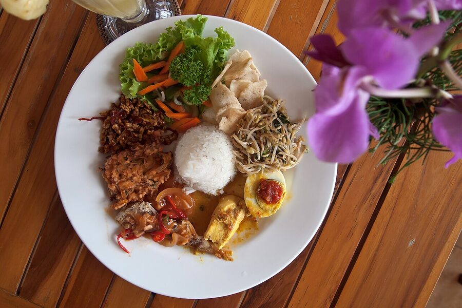 A plate of nasi campur from a warung in Ubud showing varied sides over rice