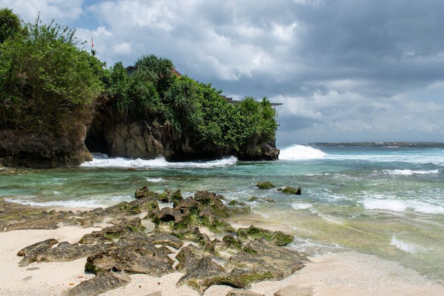 Padang Padang Beach Bali at low tide showing the cave entrance and the rock pool in the bay