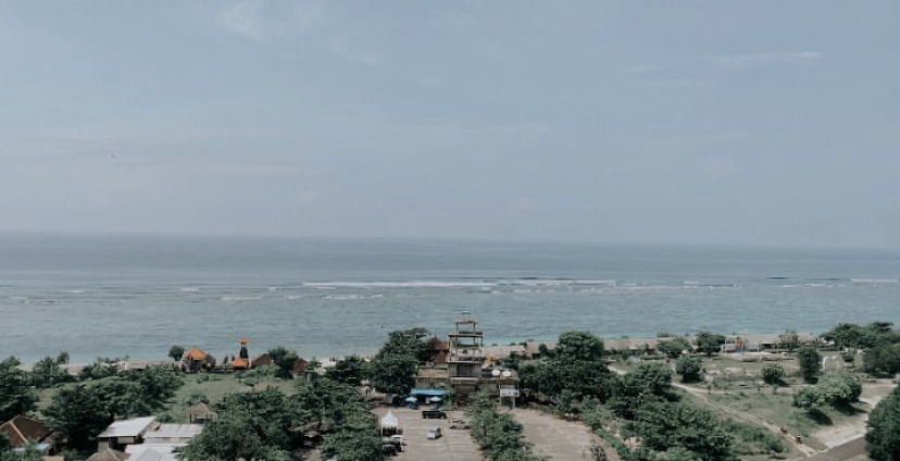 The wide white-sand beach at Pandawa Bali with calm shallow water