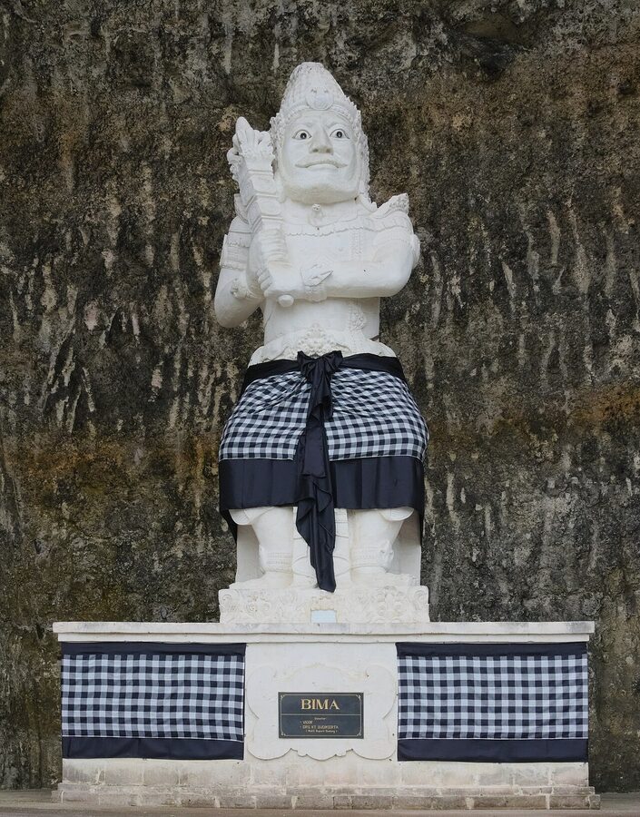 The Bima statue at Pandawa Beach Bali wearing a black-and-white poleng cloth
