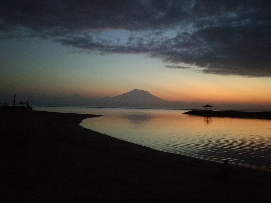 Sanur Beach at sunrise with Mt Agung silhouette across the strait, Bali