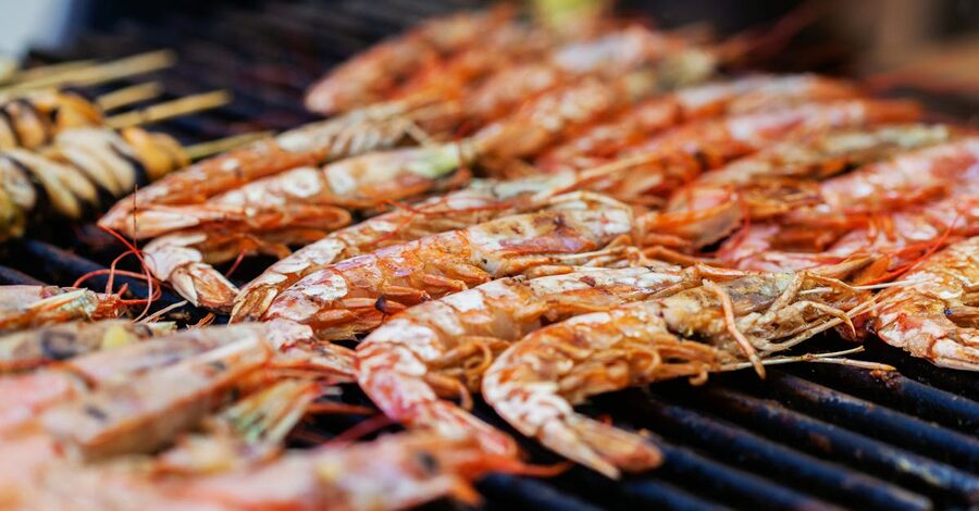 Close-up of grilled prawns on a beach grill in Bali