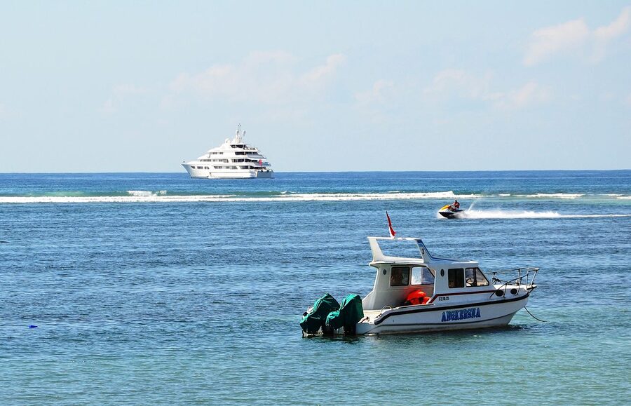 Tanjung Benoa Bali with watersports boats and a cruise yacht offshore