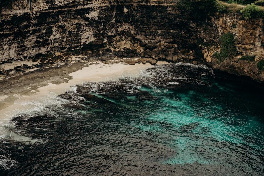 Aerial view of cliff coastline and turquoise water near Nusa Lembongan Bali