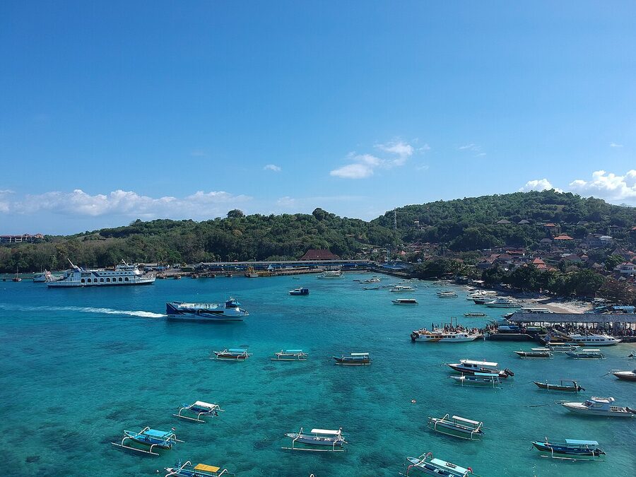 Padangbai harbour with fast boats lined up at the pier and turquoise water