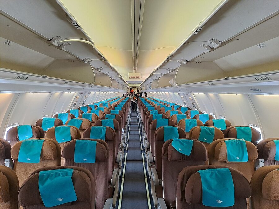 Garuda Indonesia Boeing 737 cabin interior with teal seat covers