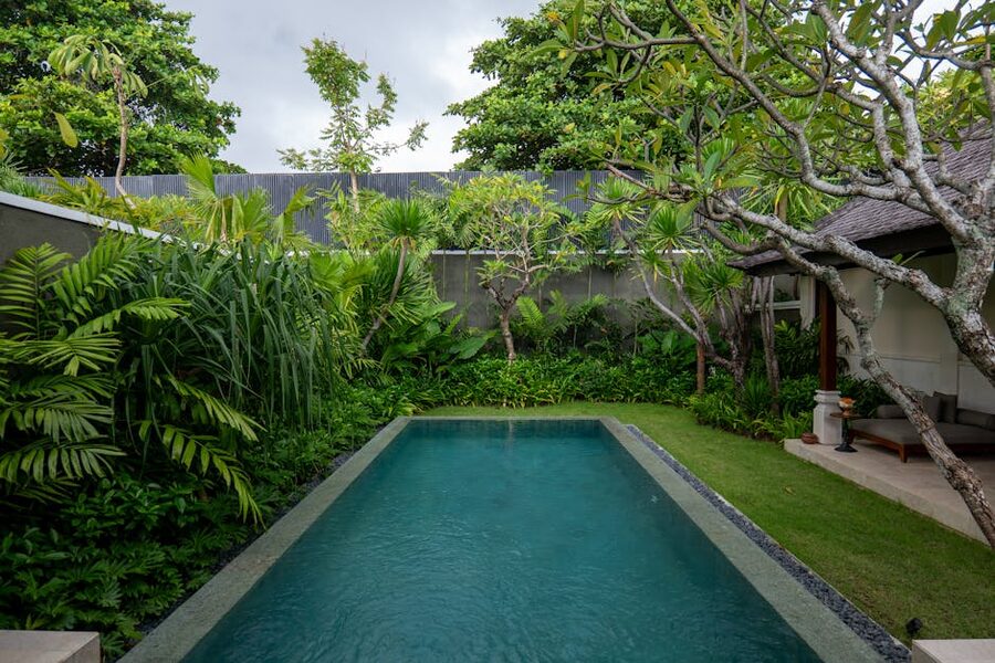 Tropical villa pool surrounded by lush garden in Bali