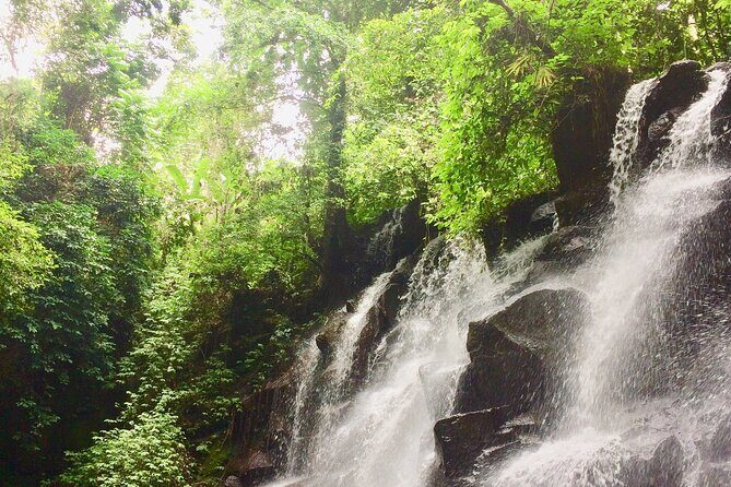 Bali best waterfall - Tukad Cepung: light through the waterfall in a cliff setting